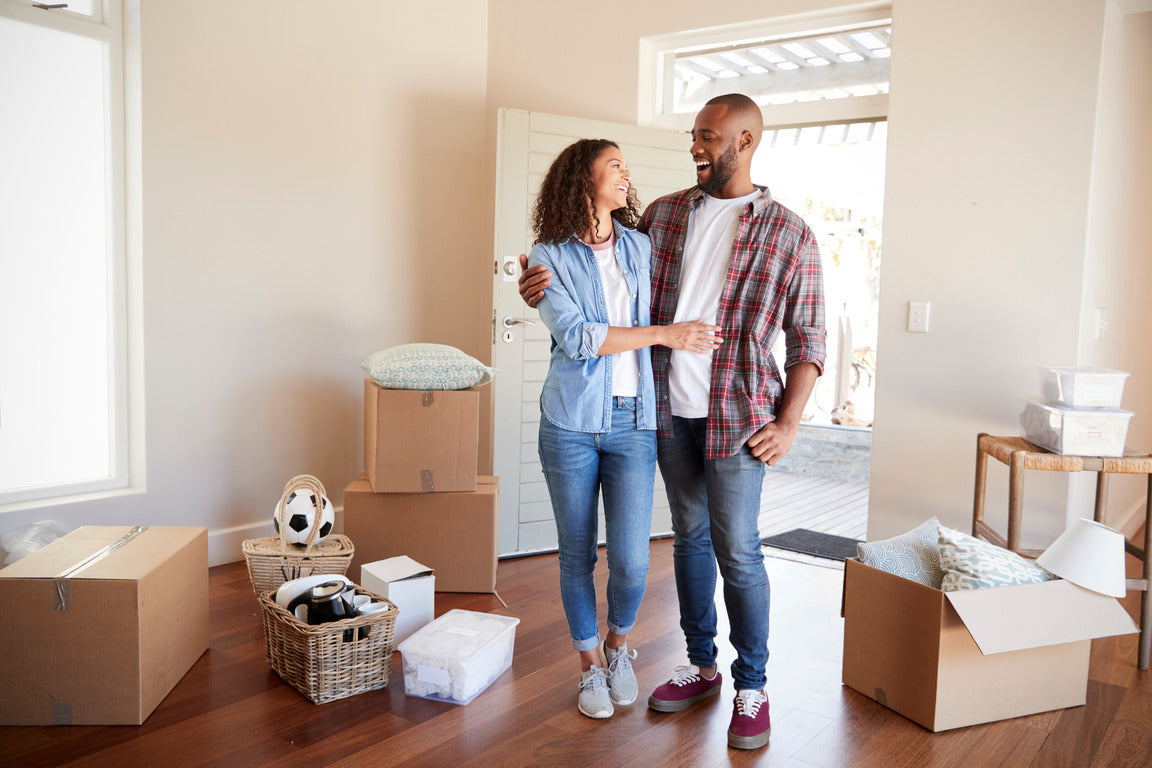 Newlyweds Surrounded By Boxes In New Home