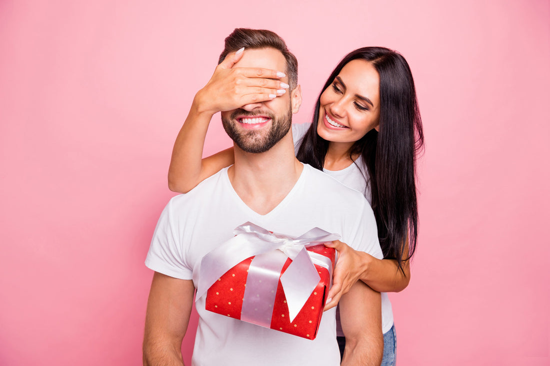 girlfriend holding valentine's gift congratulating his beloved one