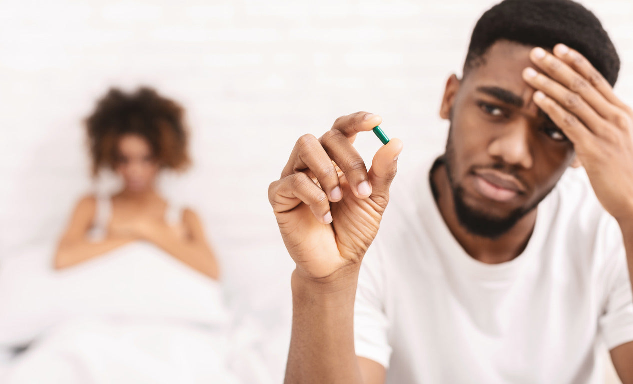 Upset guy taking potency pill before sex with girlfriend