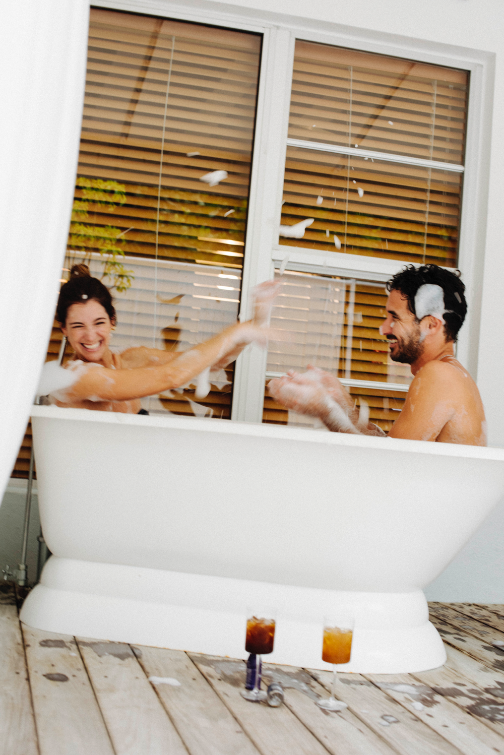 Happy couple in a tub enjoying libido drinks